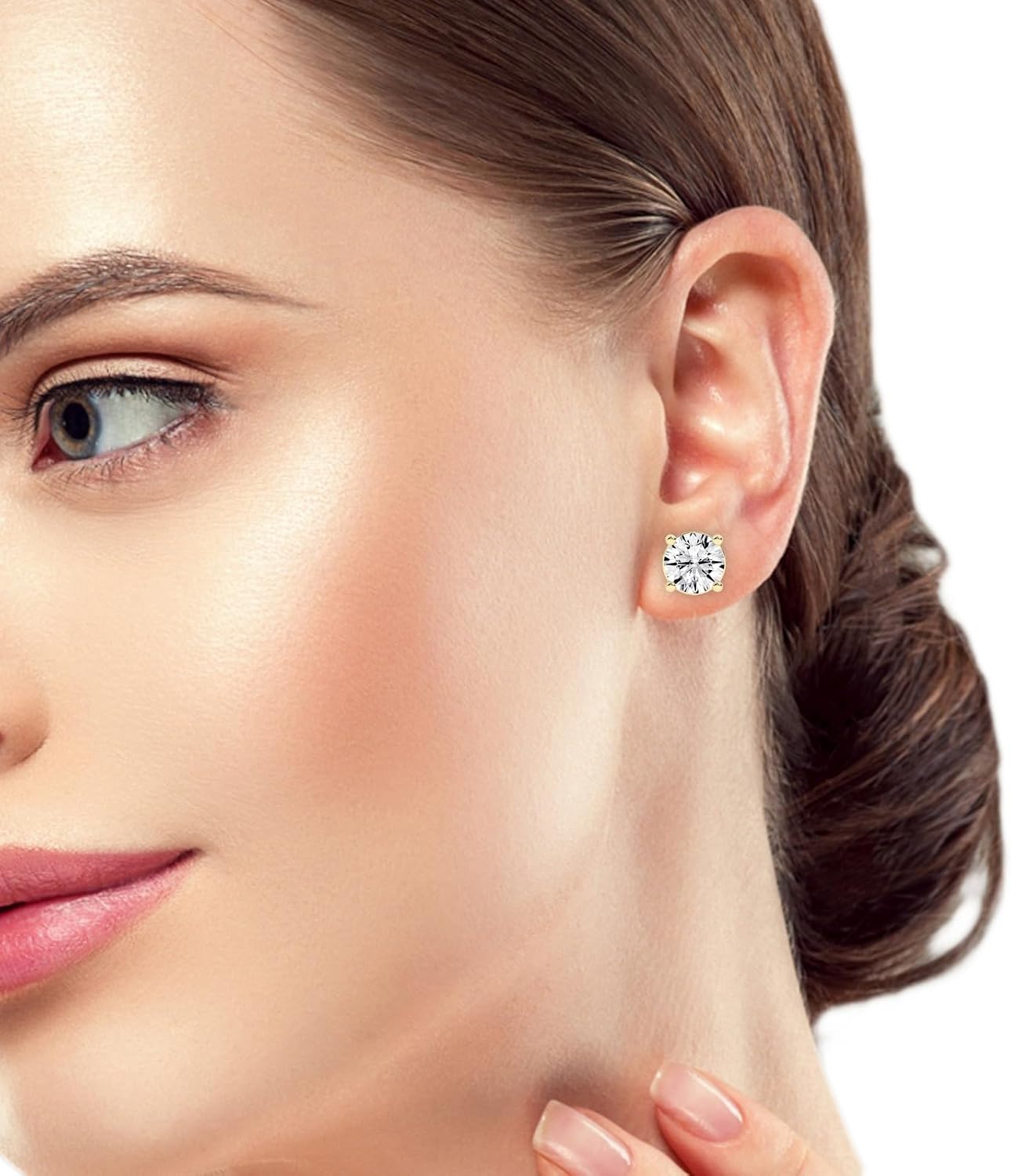 Gold-plated round diamond studs worn on the ear