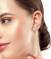 Gold-plated round diamond studs worn on the ear